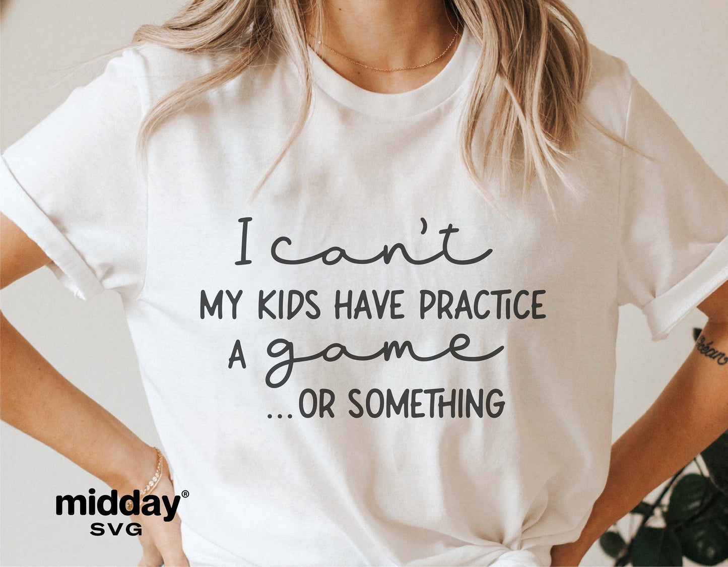 Woman wearing a white t-shirt with text 'I can't, my kids have practice, a game...or something' for sports mom humor apparel.