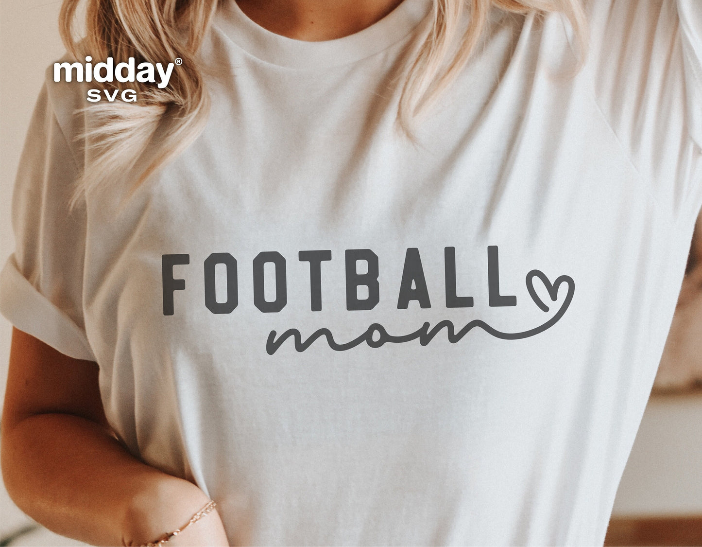 White t-shirt featuring a 'Football Mom' graphic, ideal for Cricut and Silhouette designs, with a heart detail next to 'Mom'.
