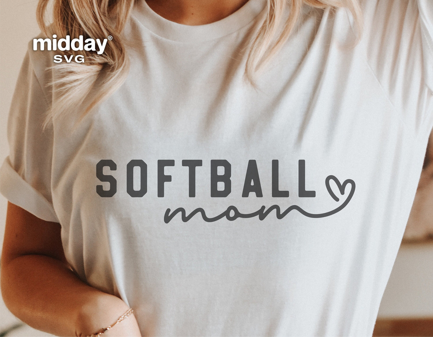 Woman wearing a white Softball Mom t-shirt showcasing a stylish Cricut design, perfect for Silhouette and sublimation projects.