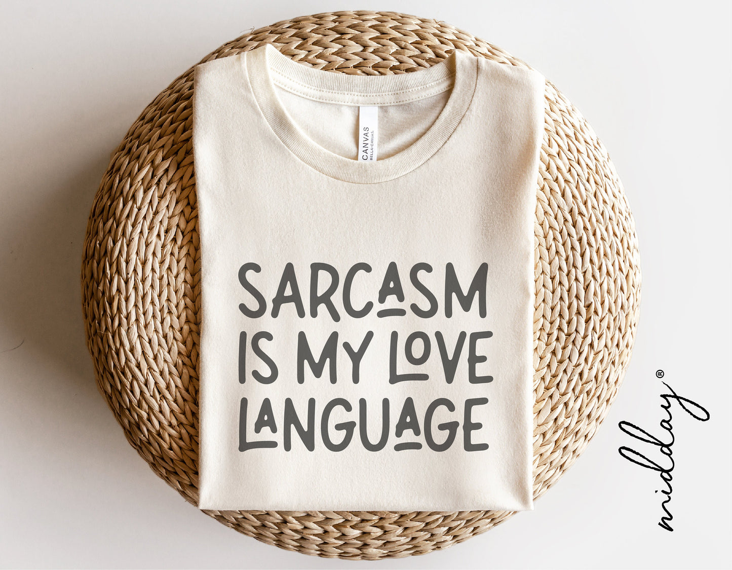 T-shirt with 'Sarcasm is My Love Language' quote, folded on a woven mat, ideal for mom shirts, Cricut, Silhouette projects