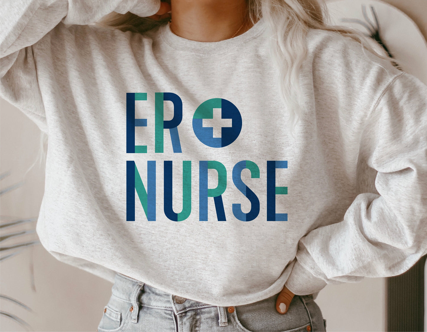 Gray sweatshirt featuring ER Nurse design in blue and teal, perfect for medical professionals.