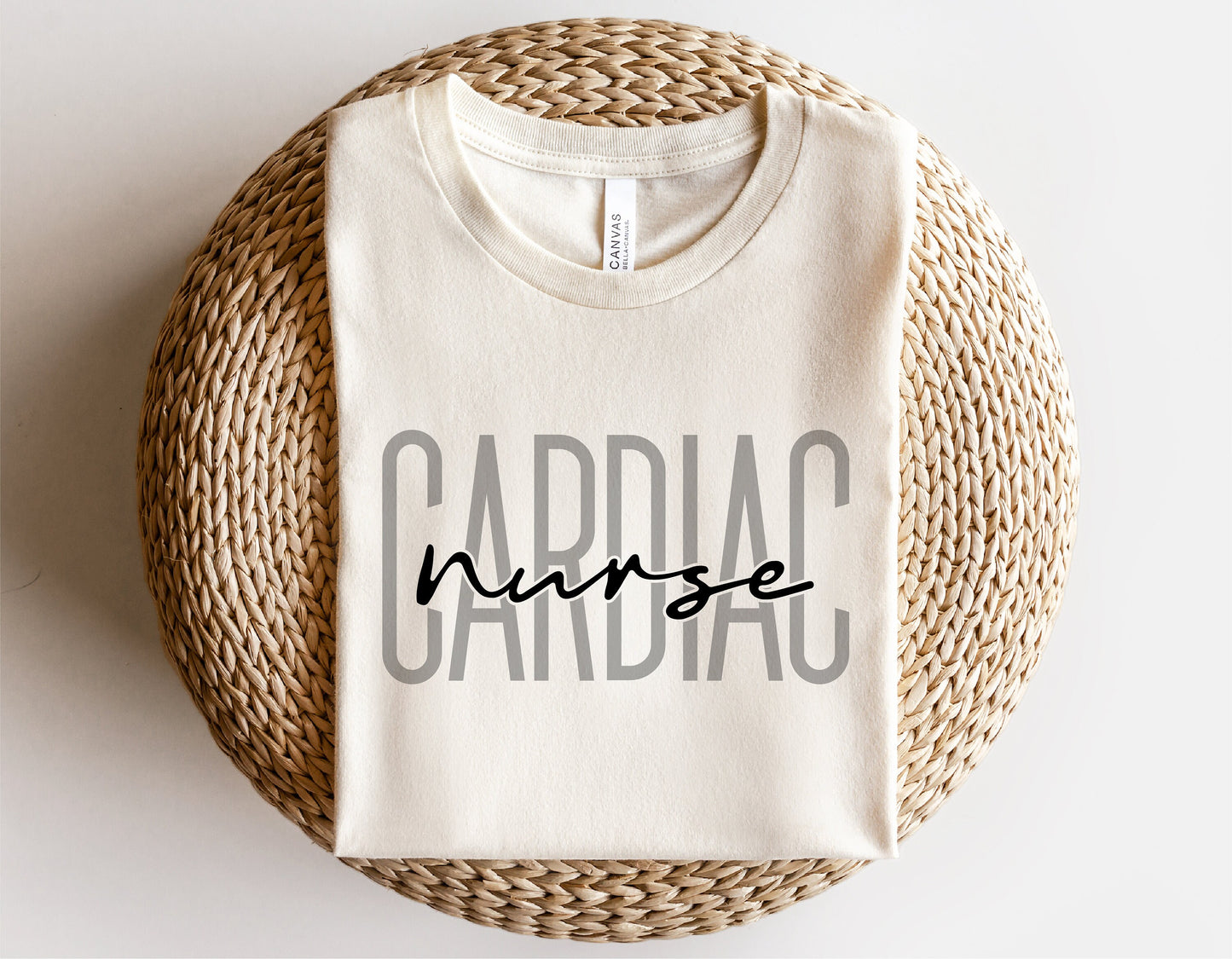 Cardiac nurse shirt with text design folded on a woven basket, perfect for digital download in SVG and PNG formats for Cricut and Silhouette.