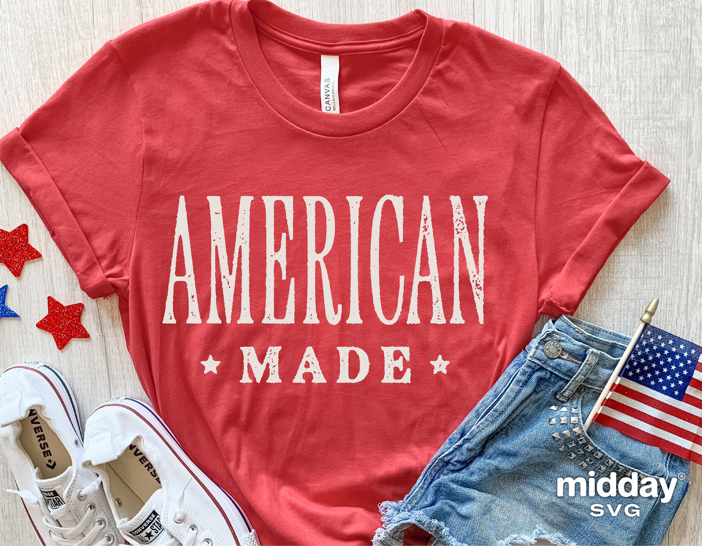 American Made red t-shirt with patriotic design, styled with sneakers, denim shorts, American flag, and star decorations for 4th of July.