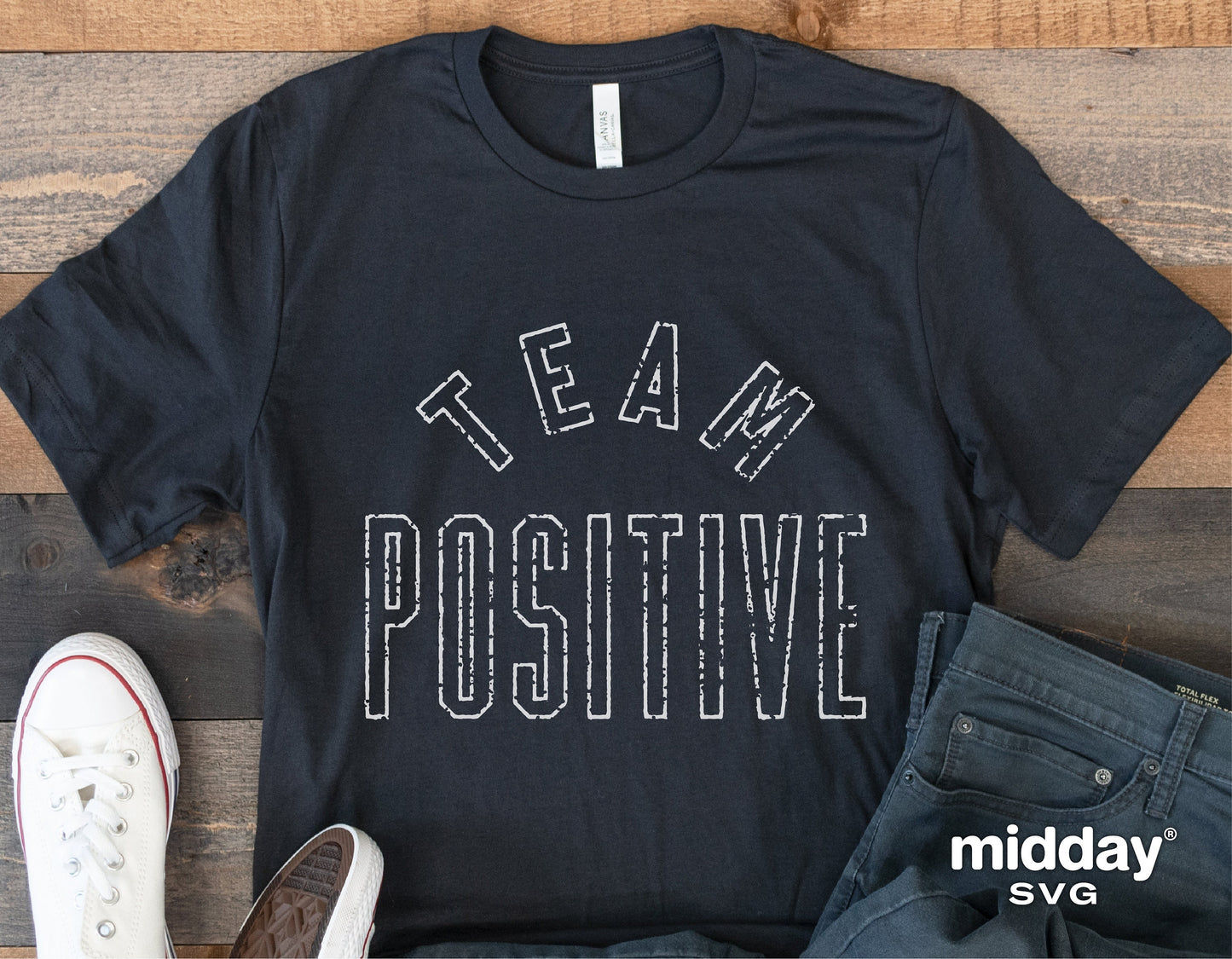 Team Positive shirt displayed with shoes and jeans, featuring inspirational text design for Cricut use.
