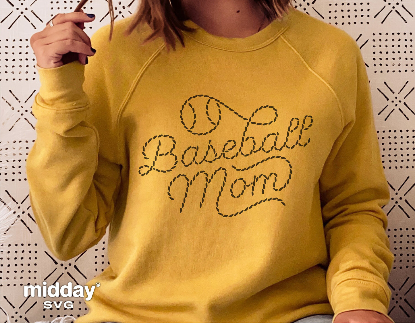 Woman wearing yellow sweatshirt with 'Baseball Mom' stitch design, ideal for Cricut and Silhouette crafting projects.