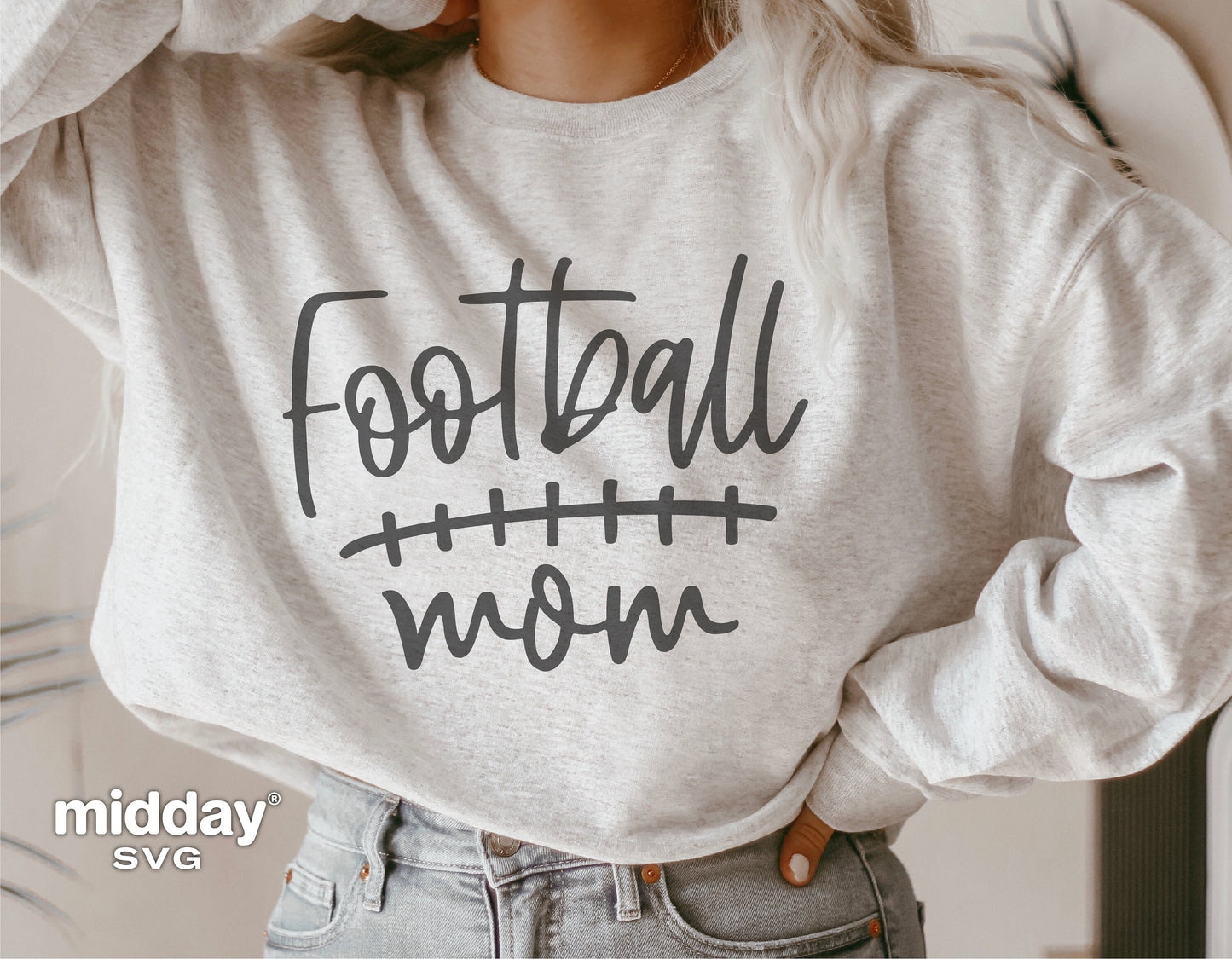 Woman wearing sweatshirt with 'Football Mom' design, perfect for Cricut or Silhouette projects, featuring hand-drawn typography.
