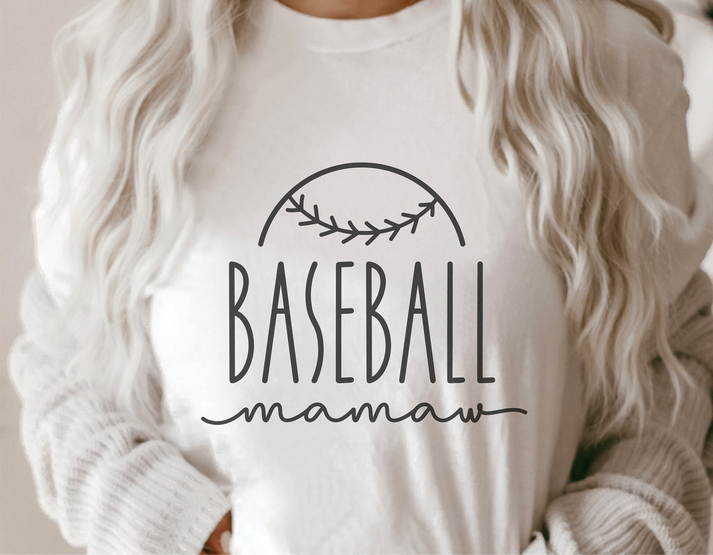 Person wearing a 'Baseball Mamaw' shirt with baseball seam design, ideal for Cricut and sublimation projects.