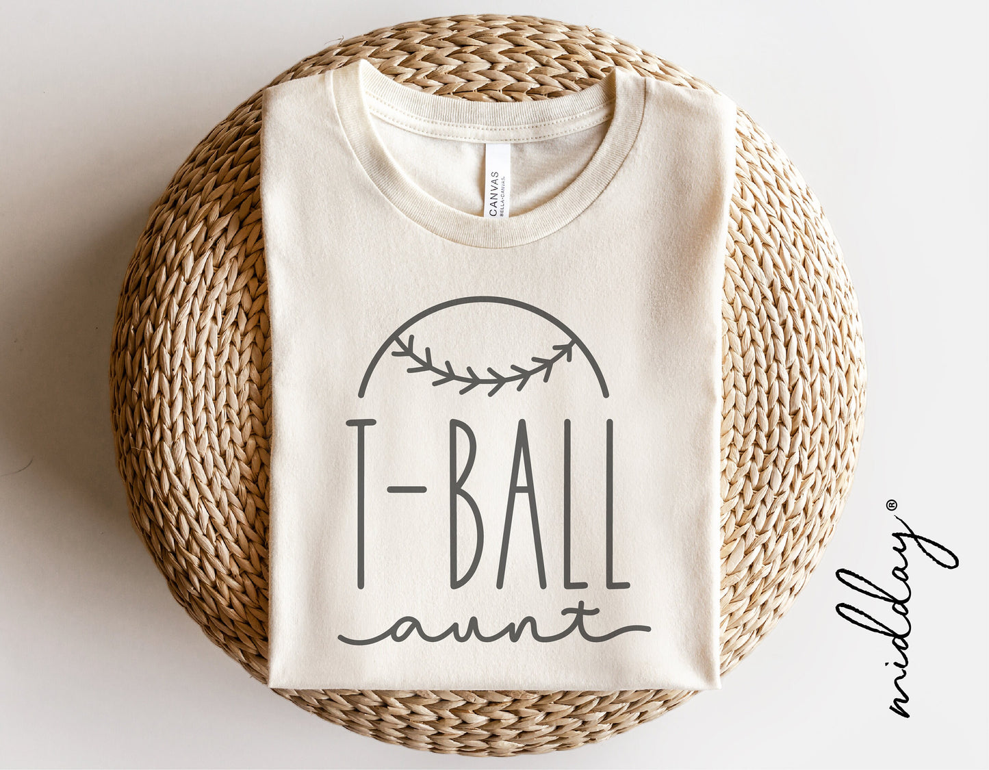 T-Ball Aunt shirt with baseball design, perfect for T-ball aunt enthusiasts, displayed on wicker background.