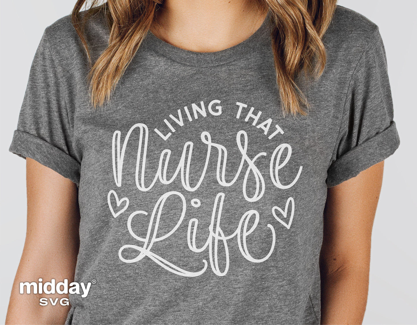 Gray t-shirt featuring 'Living That Nurse Life' script with heart embellishments, ideal for nurses and healthcare professionals.