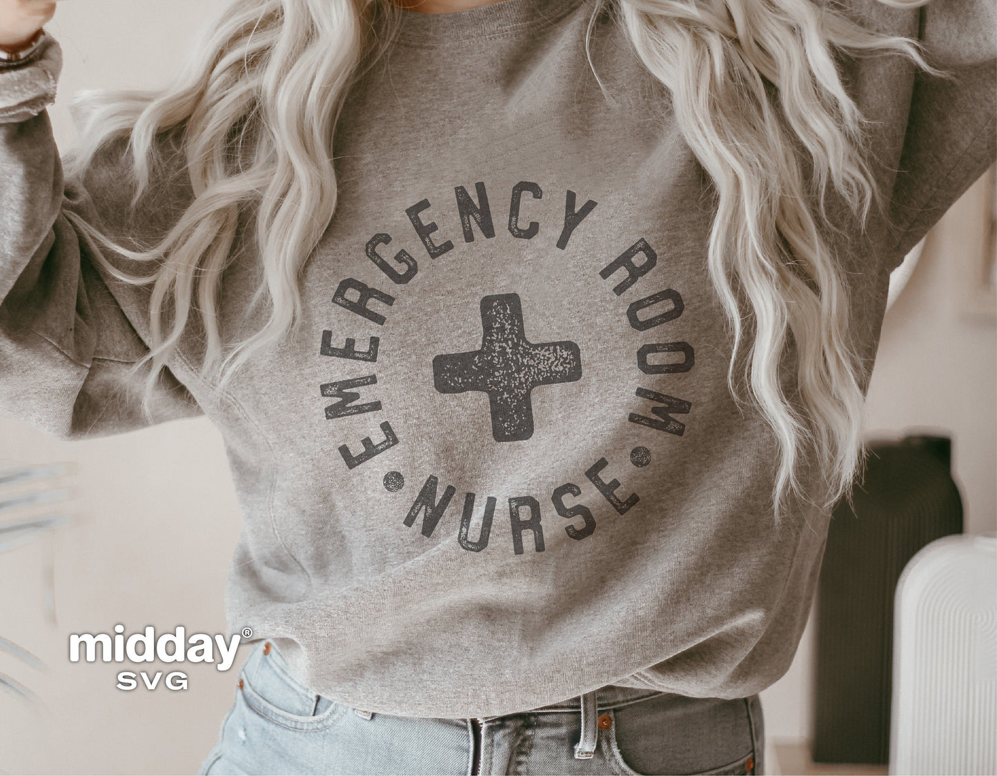 Woman wearing gray sweatshirt with 'Emergency Room Nurse' design featuring a medical cross, ideal for ER nurses and Cricut projects.