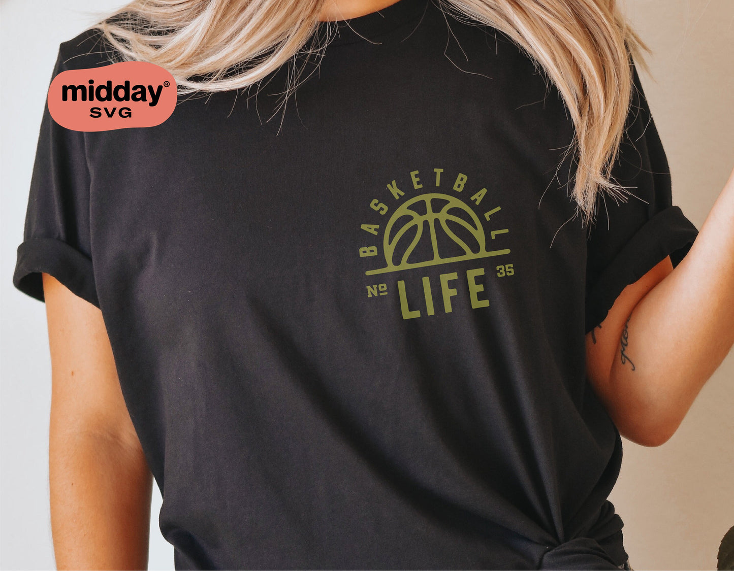 Person wearing a black t-shirt with a green 'Basketball Life' design, featuring a basketball motif resembling the sun, perfect for fans. SVG file.