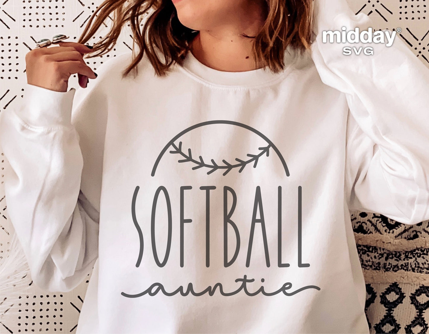 Person wearing a 'Softball Auntie' sweatshirt, featuring custom design suitable for Cricut and Silhouette projects.