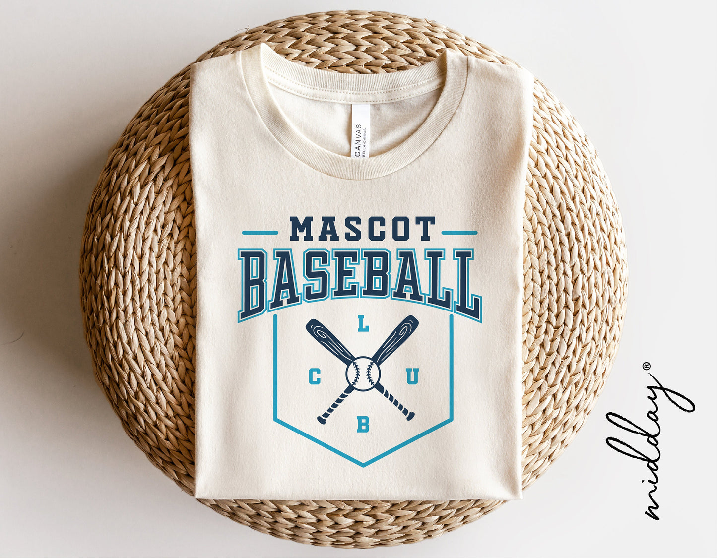 Baseball club team shirt with mascot logo design, folded neatly on a woven mat. Ideal for Cricut cut files and team gifts.