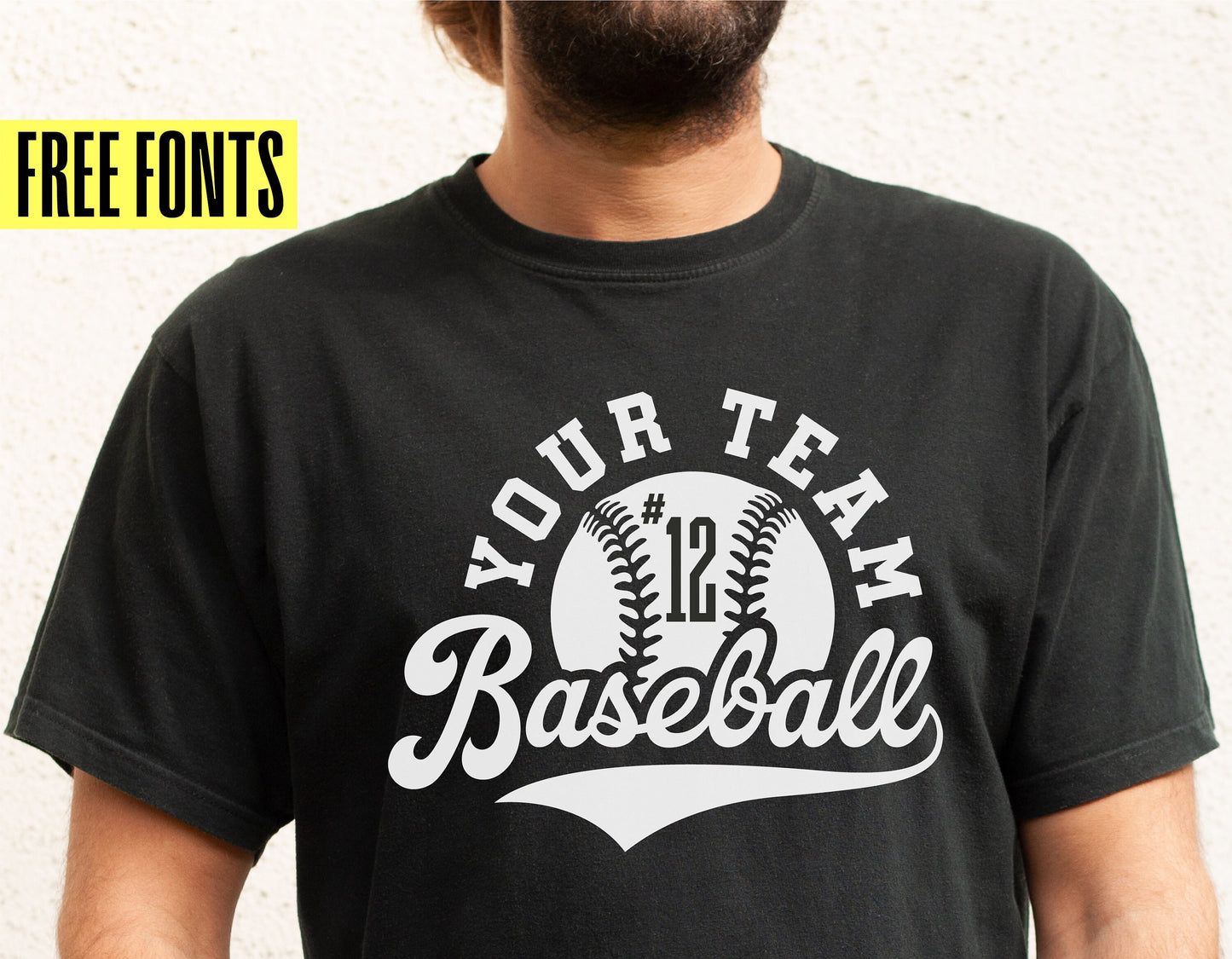 Person wearing a personalized black baseball t-shirt with team logo and number, featuring free fonts offer on the side.
