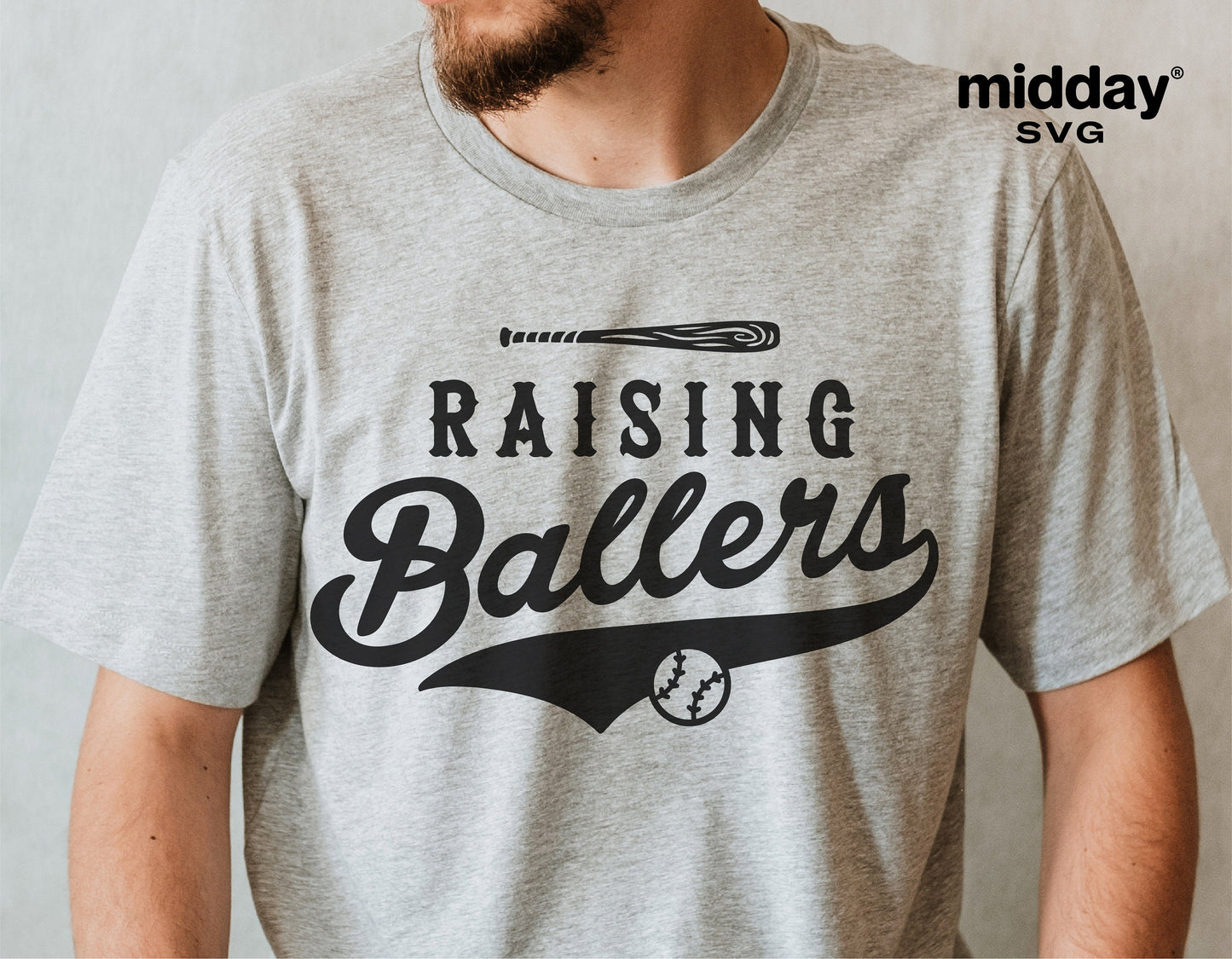 Man wearing 'Raising Ballers' baseball-themed graphic tee in gray color.