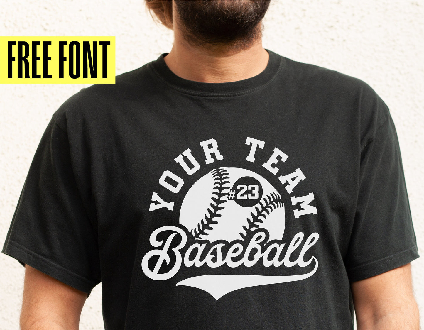Person wearing a black baseball team shirt template with customizable text and number, featuring a baseball graphic. Free font included.