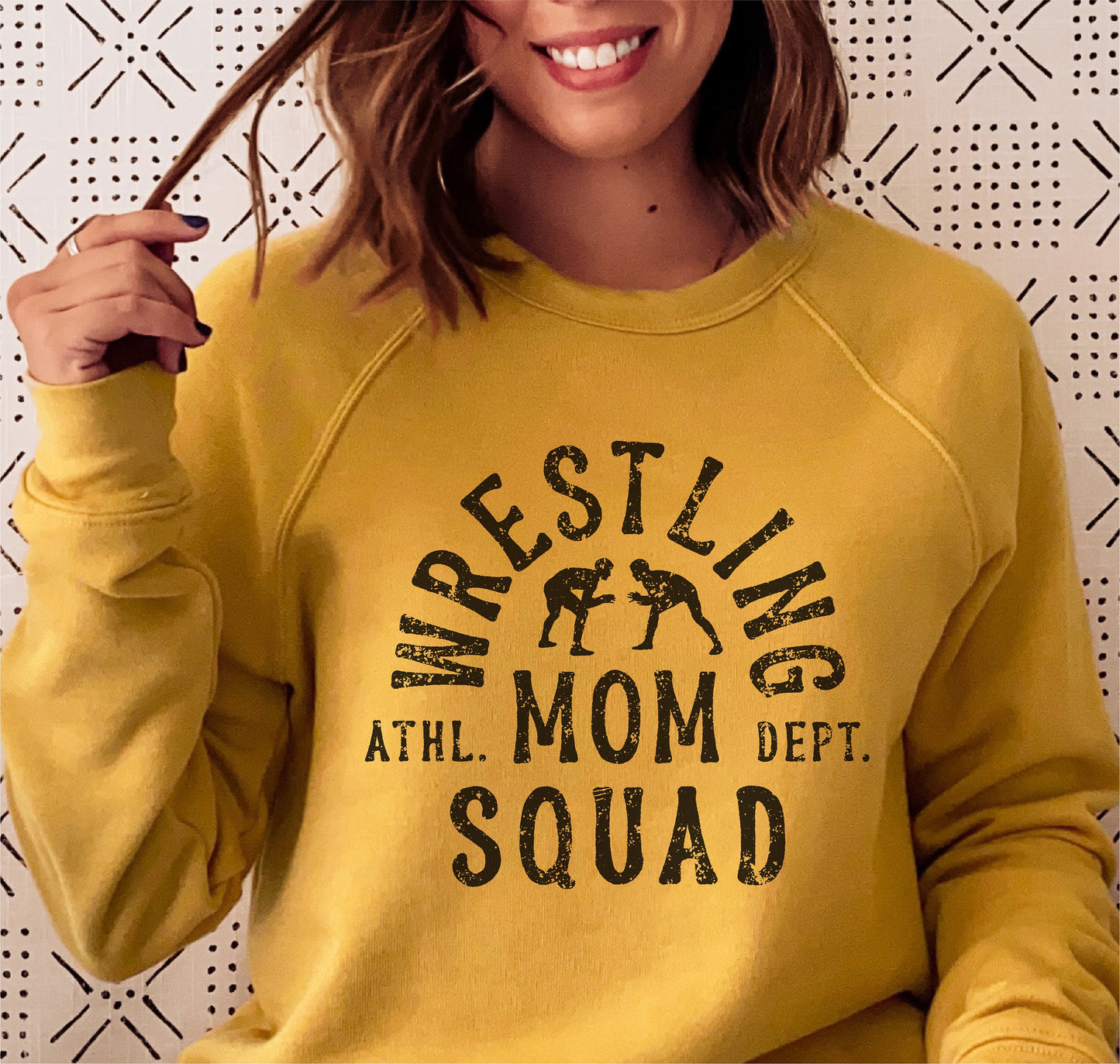 Woman wearing yellow 'Wrestling Mom Squad' sweater, perfect Cricut cut file for creating shirts, hoodies, and more.