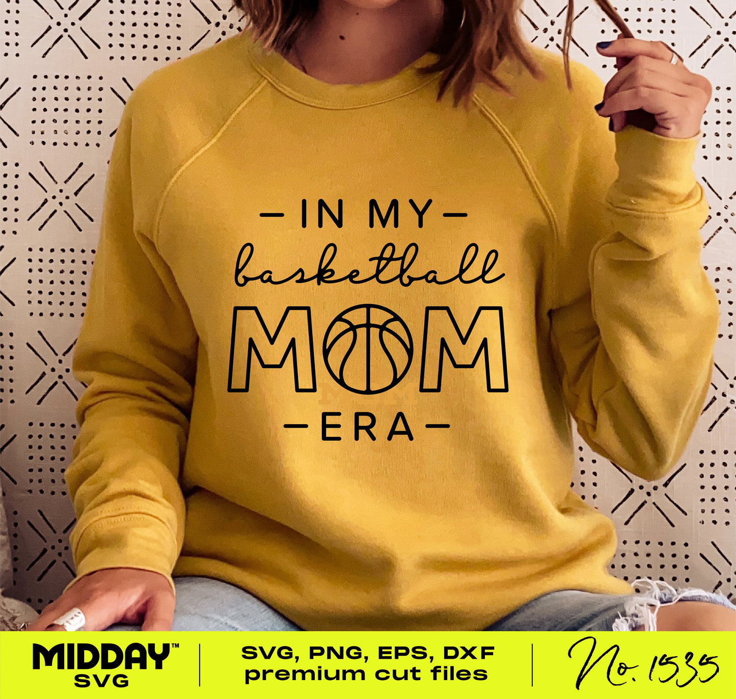 Person wearing a yellow sweatshirt with 'In My Basketball Mom Era' text, available as SVG PNG for Cricut and Silhouette crafting projects.