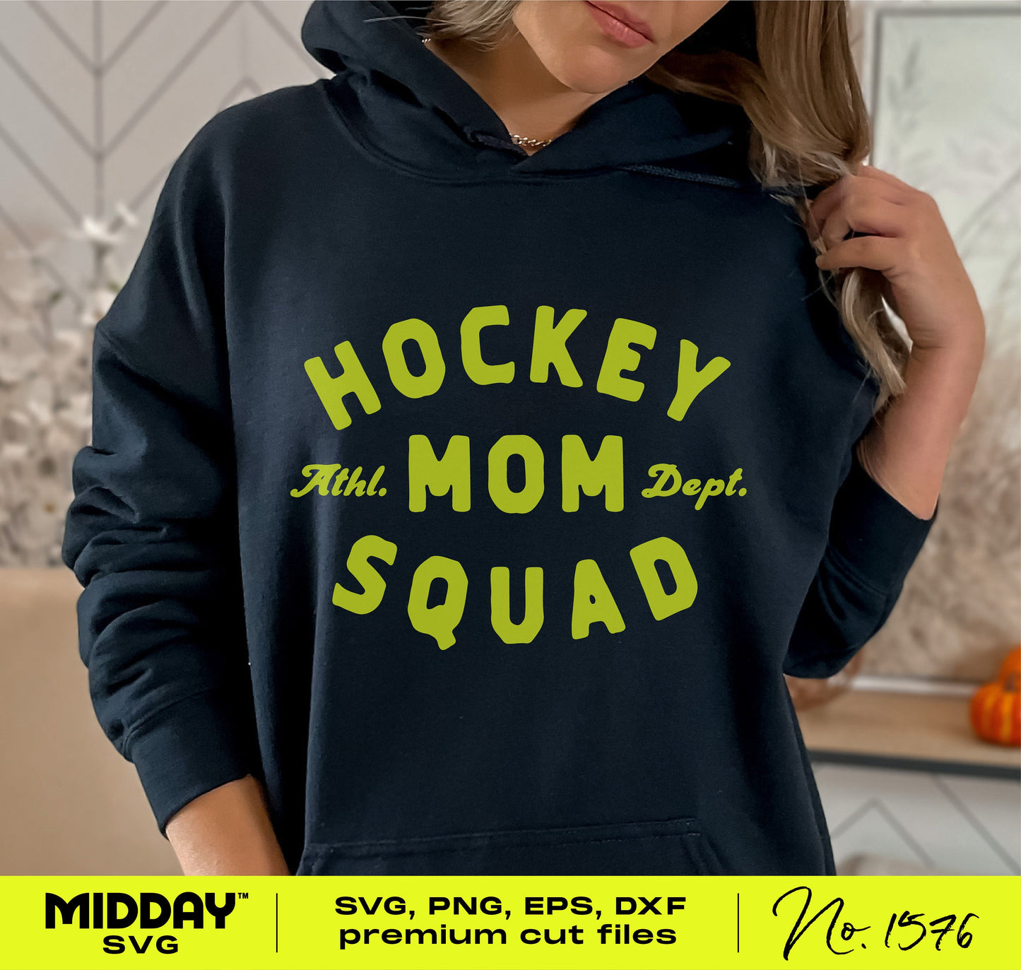 Woman wearing a hoodie with 'Hockey Mom Squad' design in yellow, showcasing trendy typography for fans.