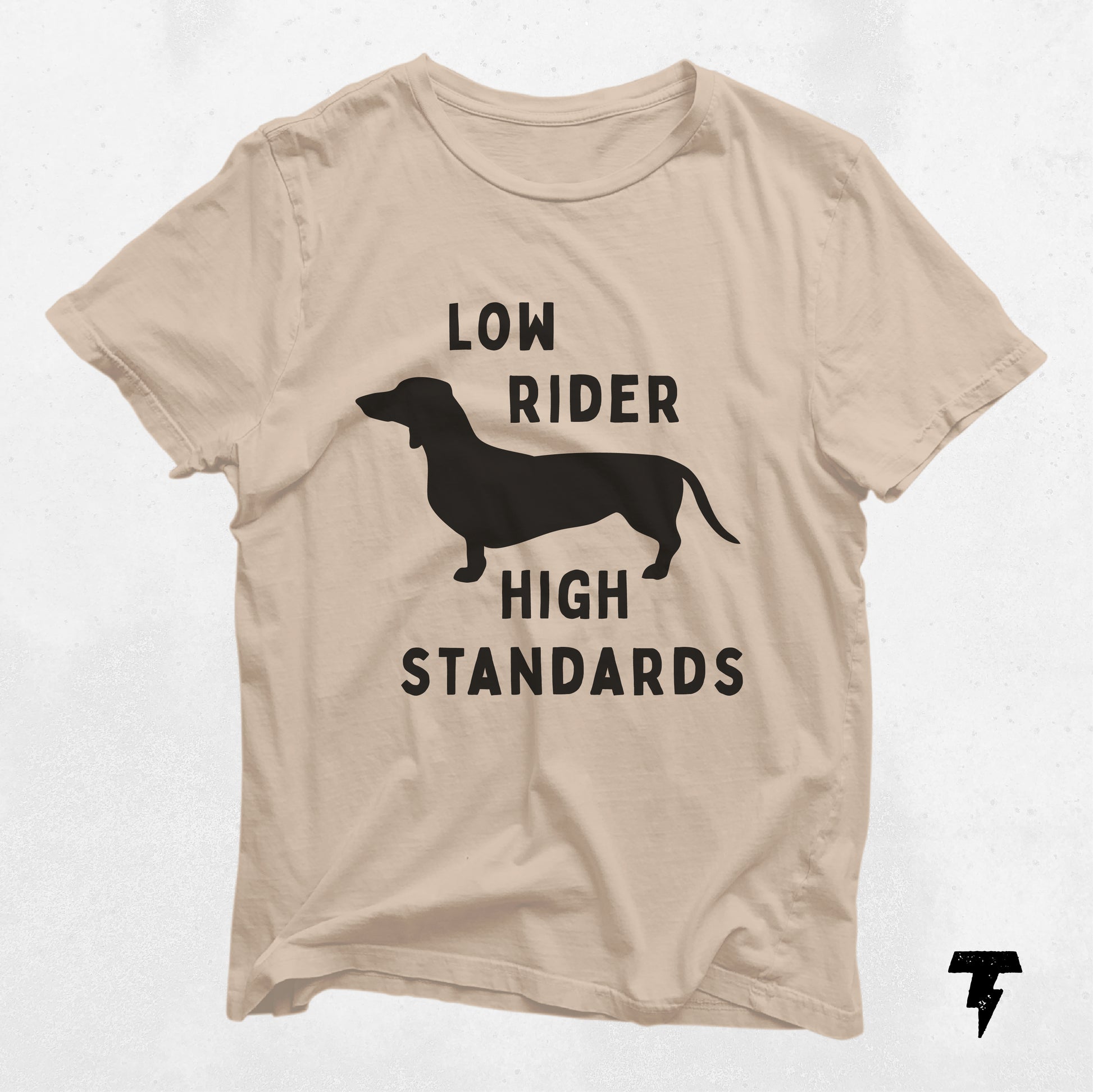 Beige t-shirt featuring a dachshund silhouette with 'Low Rider High Standards' text, ideal gift for dog moms and dachshund enthusiasts.