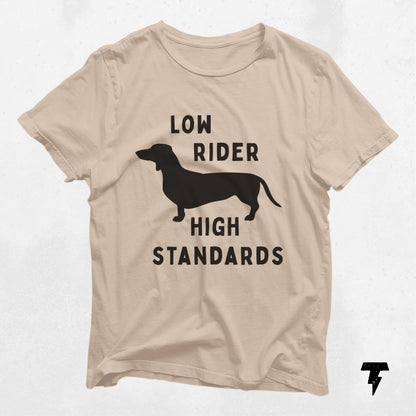 Beige t-shirt featuring a dachshund silhouette with 'Low Rider High Standards' text, ideal gift for dog moms and dachshund enthusiasts.