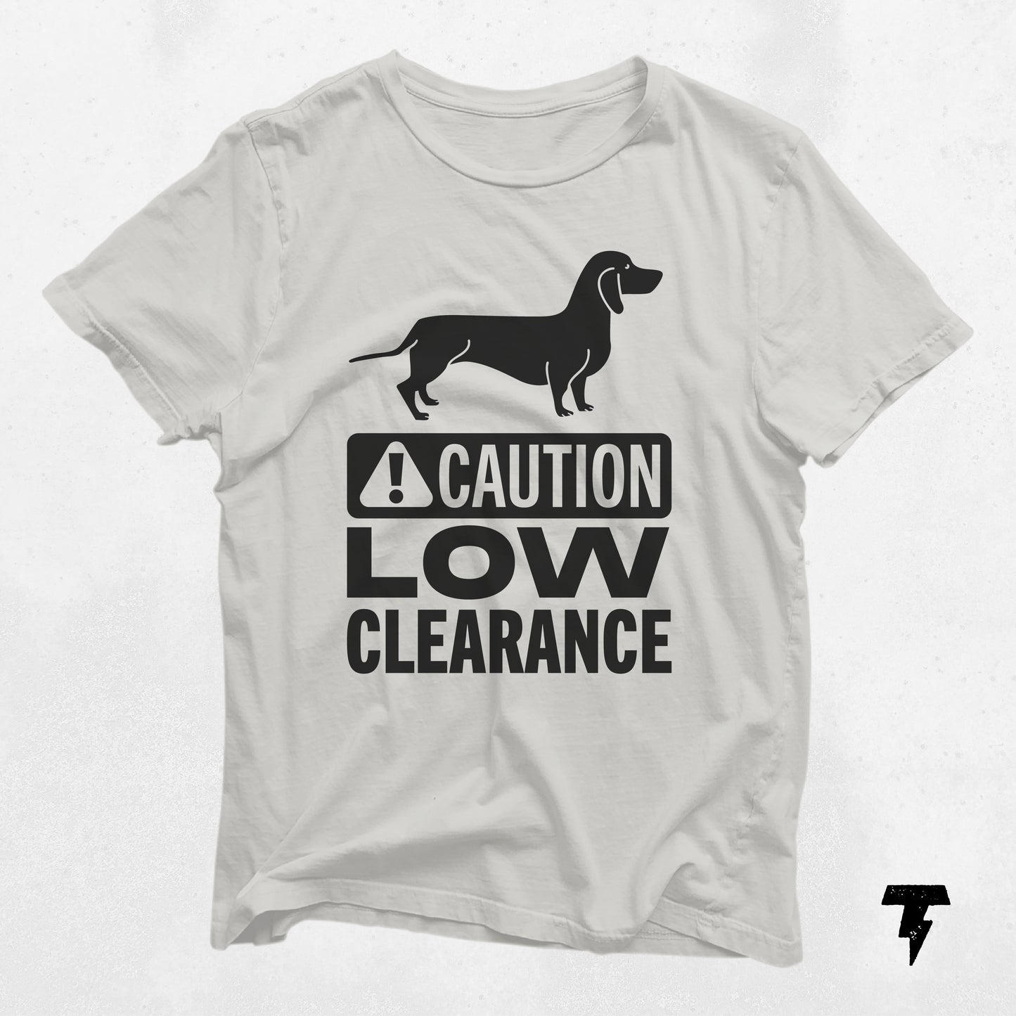 White t-shirt featuring "Caution Low Clearance" text and dachshund graphic, perfect gift for dog moms and dachshund lovers.
