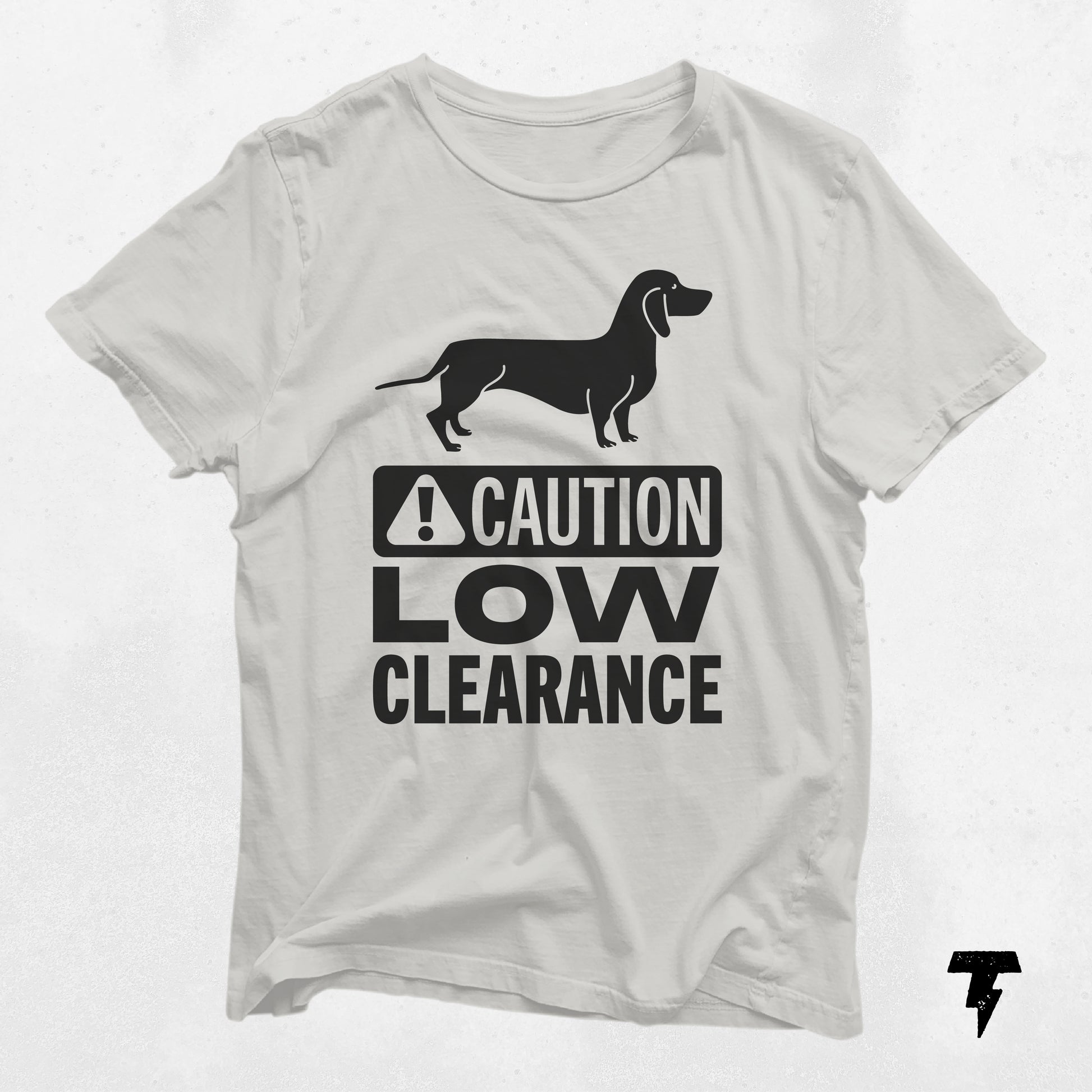 White t-shirt featuring "Caution Low Clearance" text and dachshund graphic, perfect gift for dog moms and dachshund lovers.