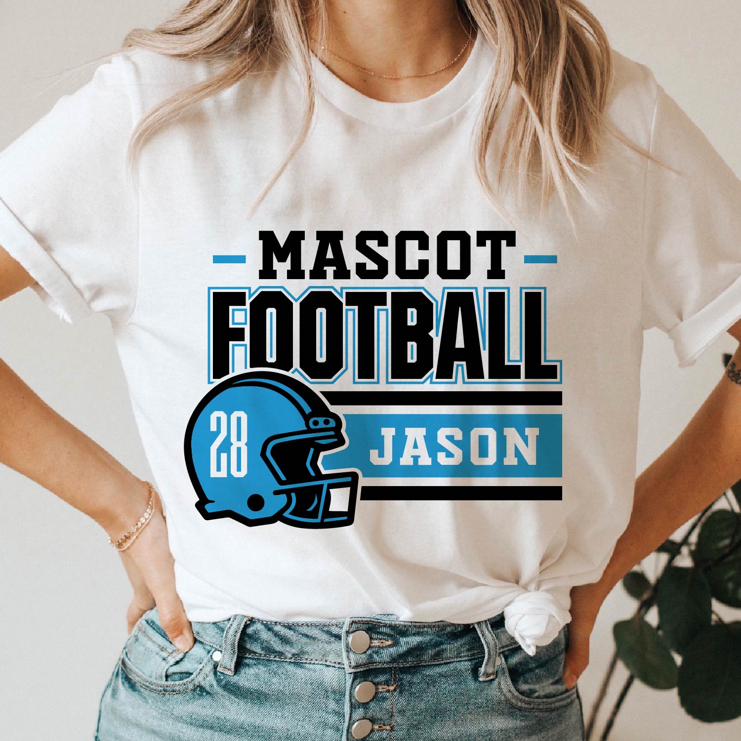 Person wearing a customized football team t-shirt with mascot helmet, player name, 'Jason', and number '28' in blue and black design.