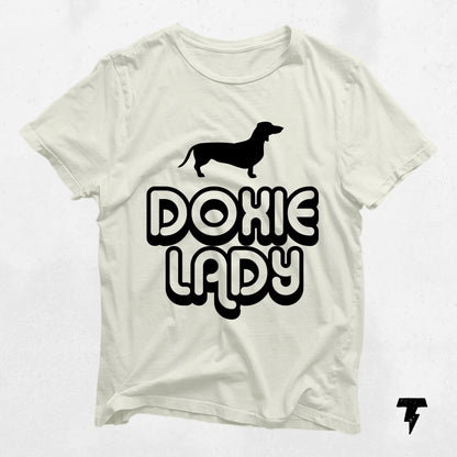 "Doxie Lady" dachshund graphic tee, soft cotton, perfect gift for dog moms, white shirt with black text and dog silhouette.