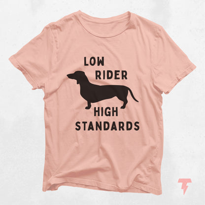 Pink dachshund shirt with 'Low Rider High Standards' text and silhouette design, perfect for dog moms and doxie lovers.
