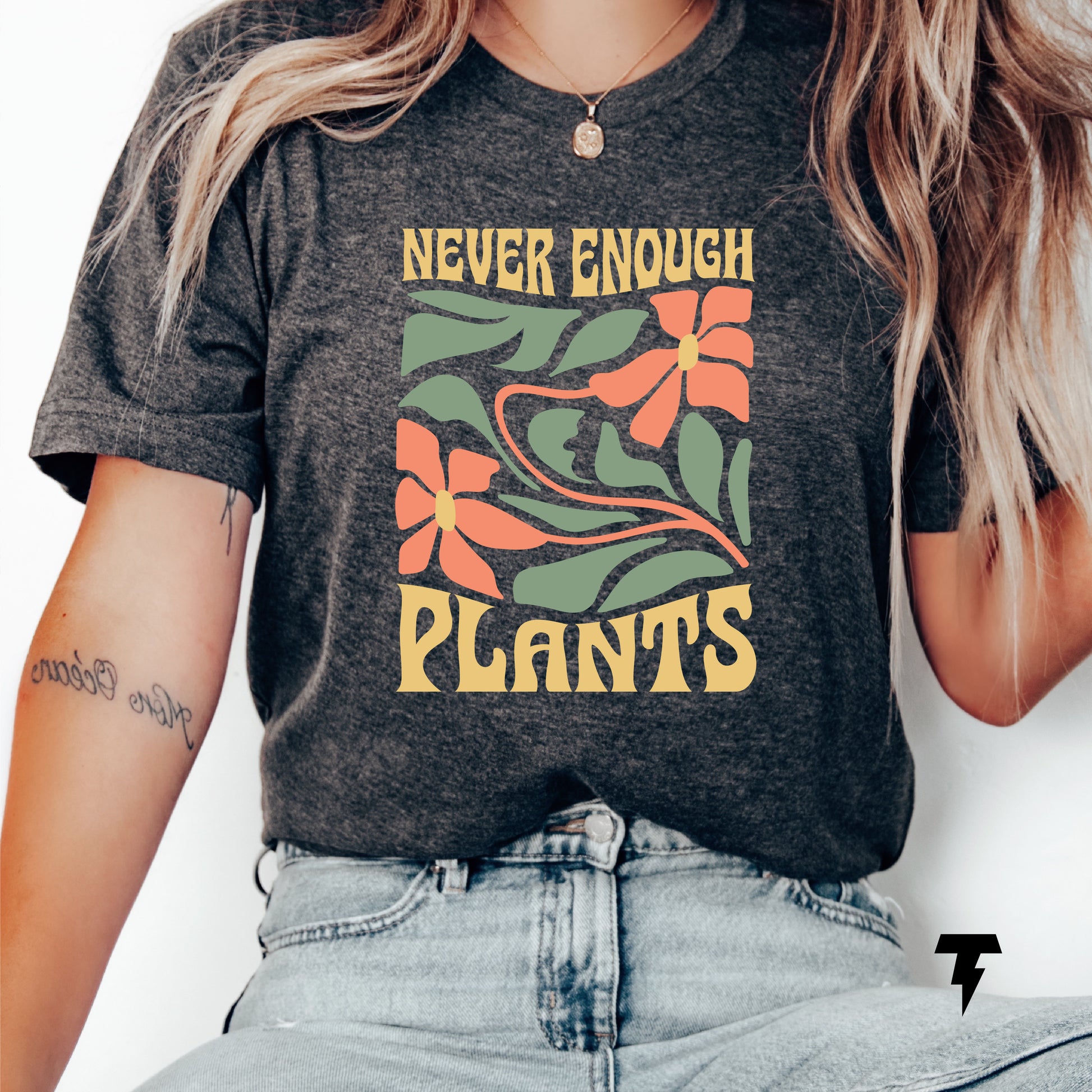 Woman wearing 'Never Enough Plants' shirt with floral design, perfect plant lover gift, casual gardening attire.