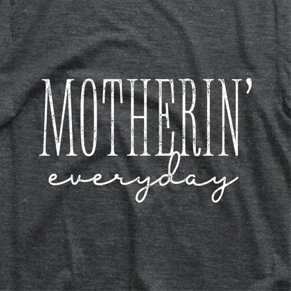 "Motherin' Everyday" funny mom shirt in black. 100% cotton, perfect baby shower gift, casual fit. Machine wash cold.