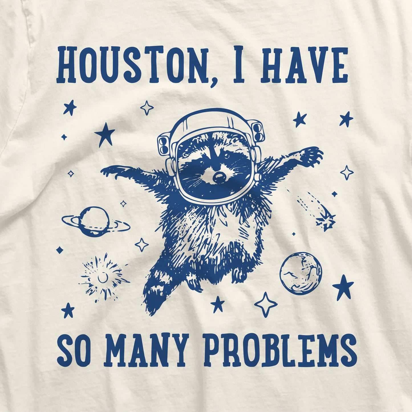 "Houston I Have So Many Problems" t-shirt featuring raccoon astronaut in space with planets and stars.