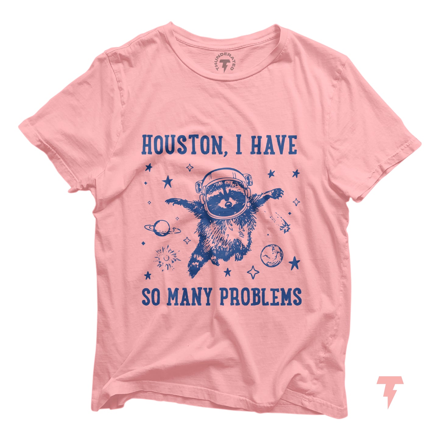 Pink t-shirt with 'Houston, I Have So Many Problems' featuring a raccoon astronaut in space, embracing chaotic fun.