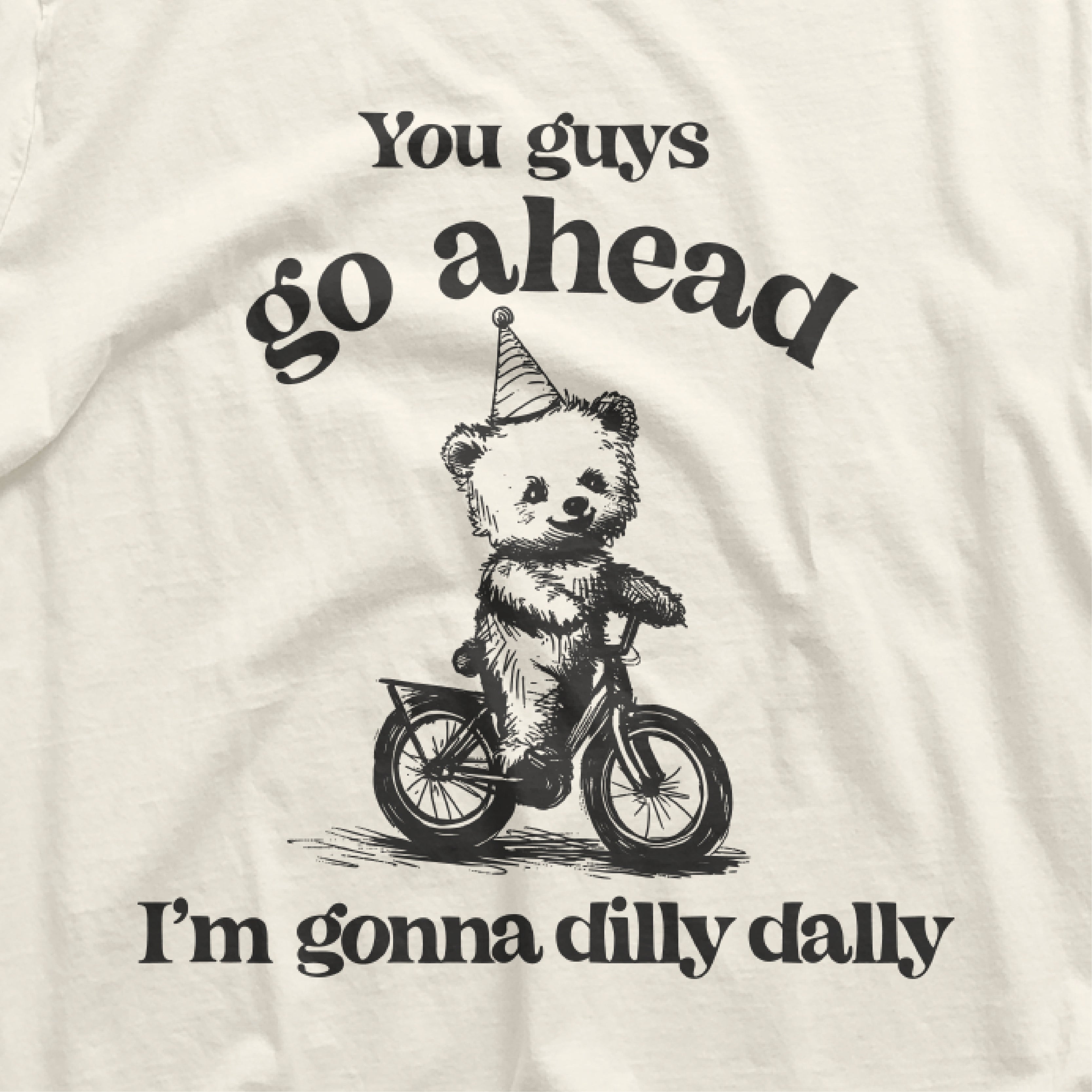 a white shirt with a bear riding a bike