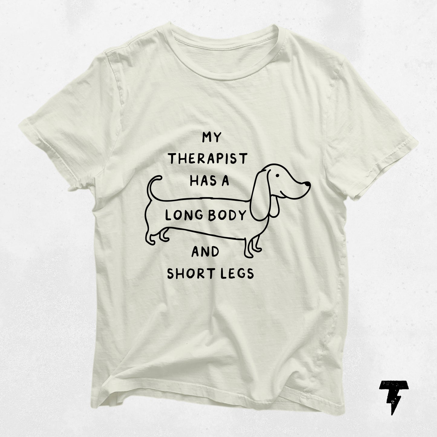 Beige dachshund shirt with 'My Therapist has a Long Body and Short Legs' print, perfect gift for dog moms and doxie lovers.