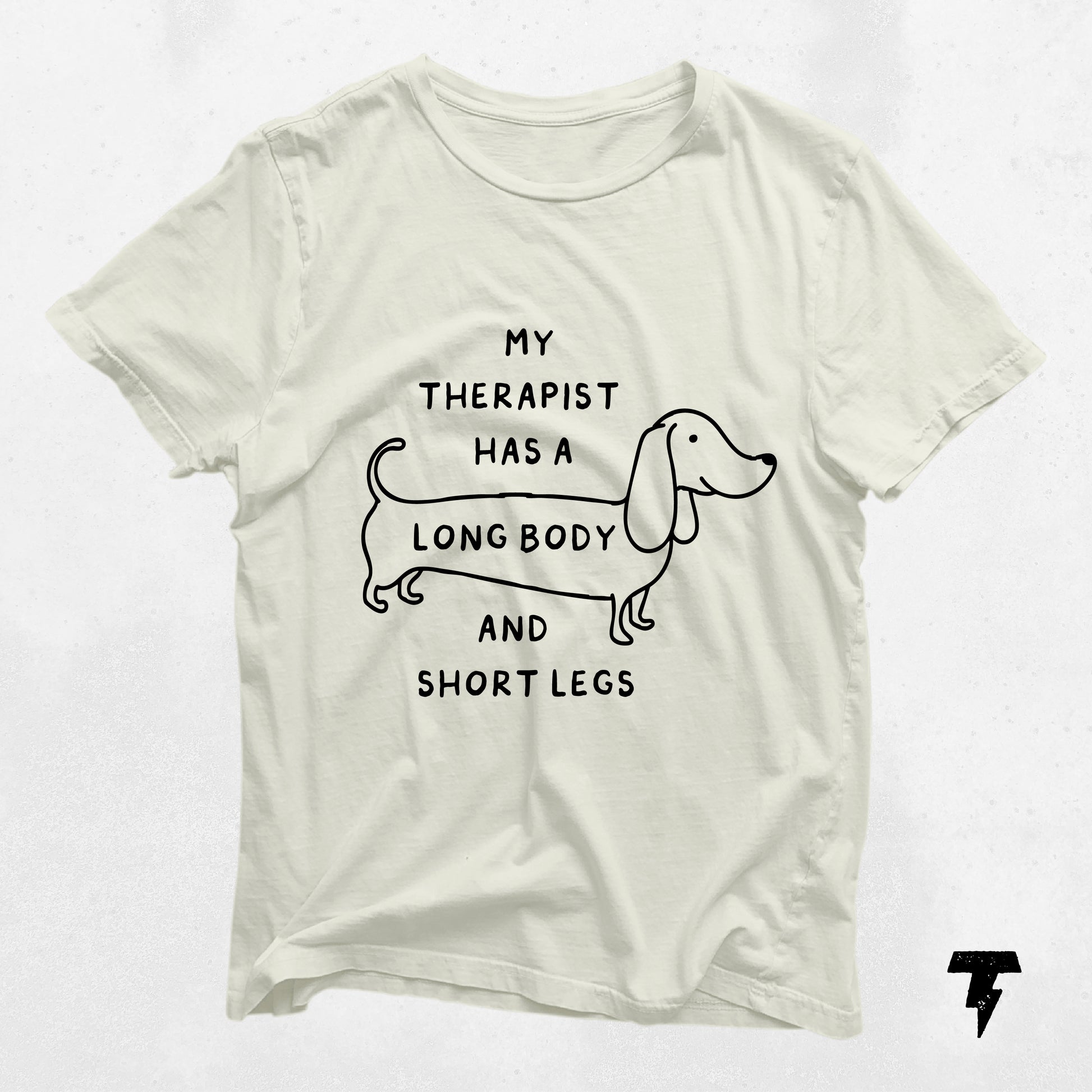 Beige dachshund shirt with 'My Therapist has a Long Body and Short Legs' print, perfect gift for dog moms and doxie lovers.