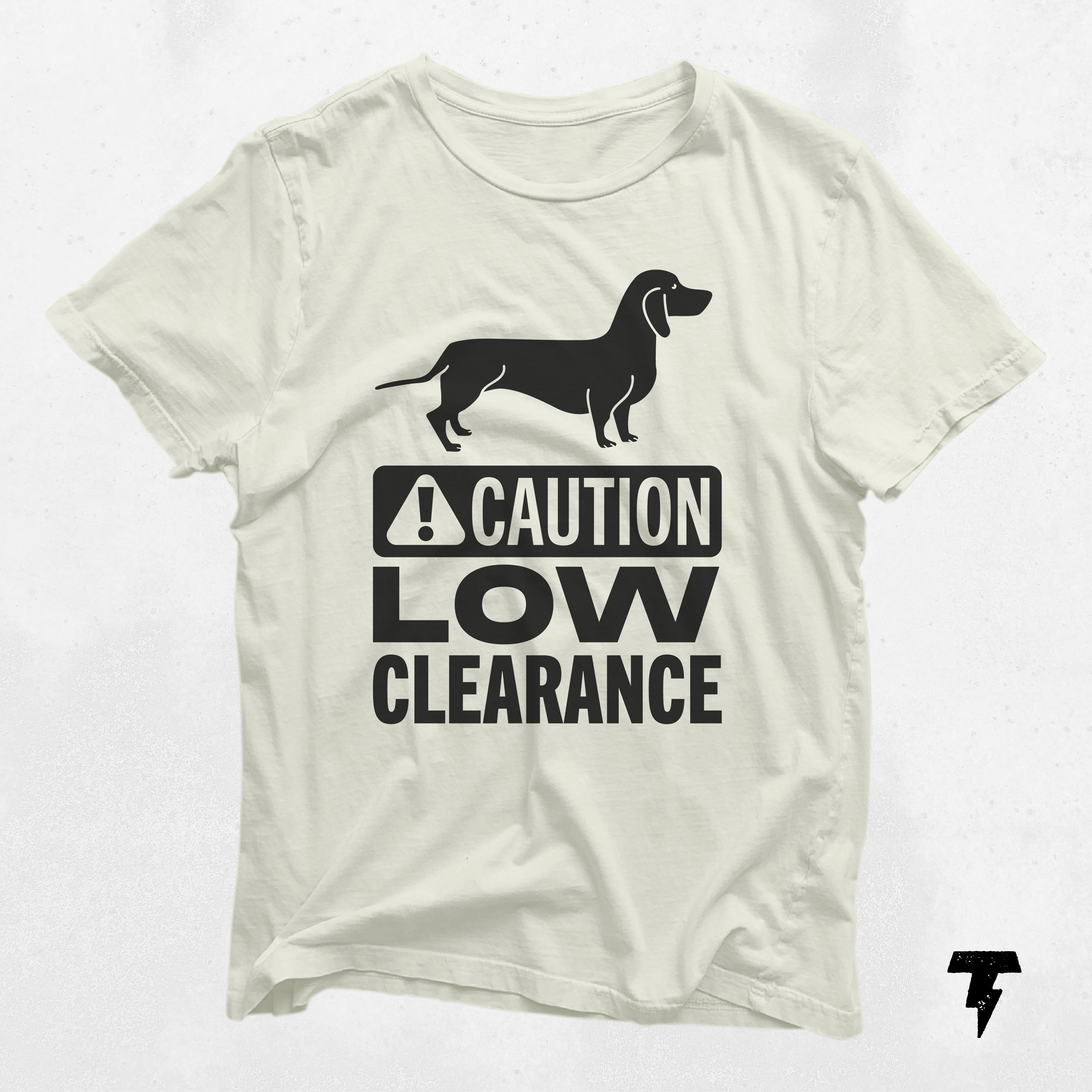 a white t - shirt with a black dog on it that says caution low clearance