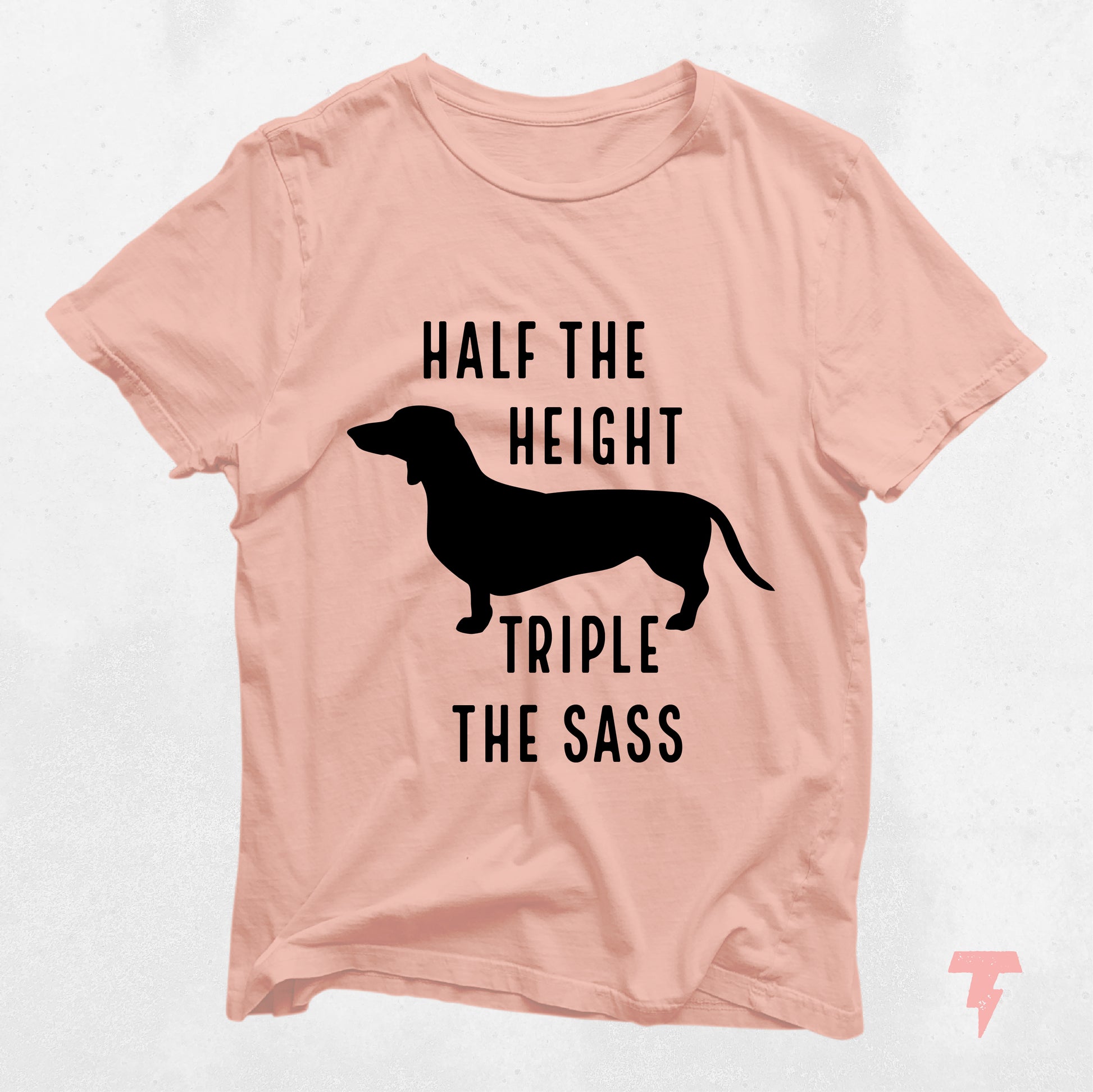 Peach Dachshund shirt with 'Half the Height, Triple the Sass' text, featuring a silhouette of a Doxie. Ideal for dog moms.