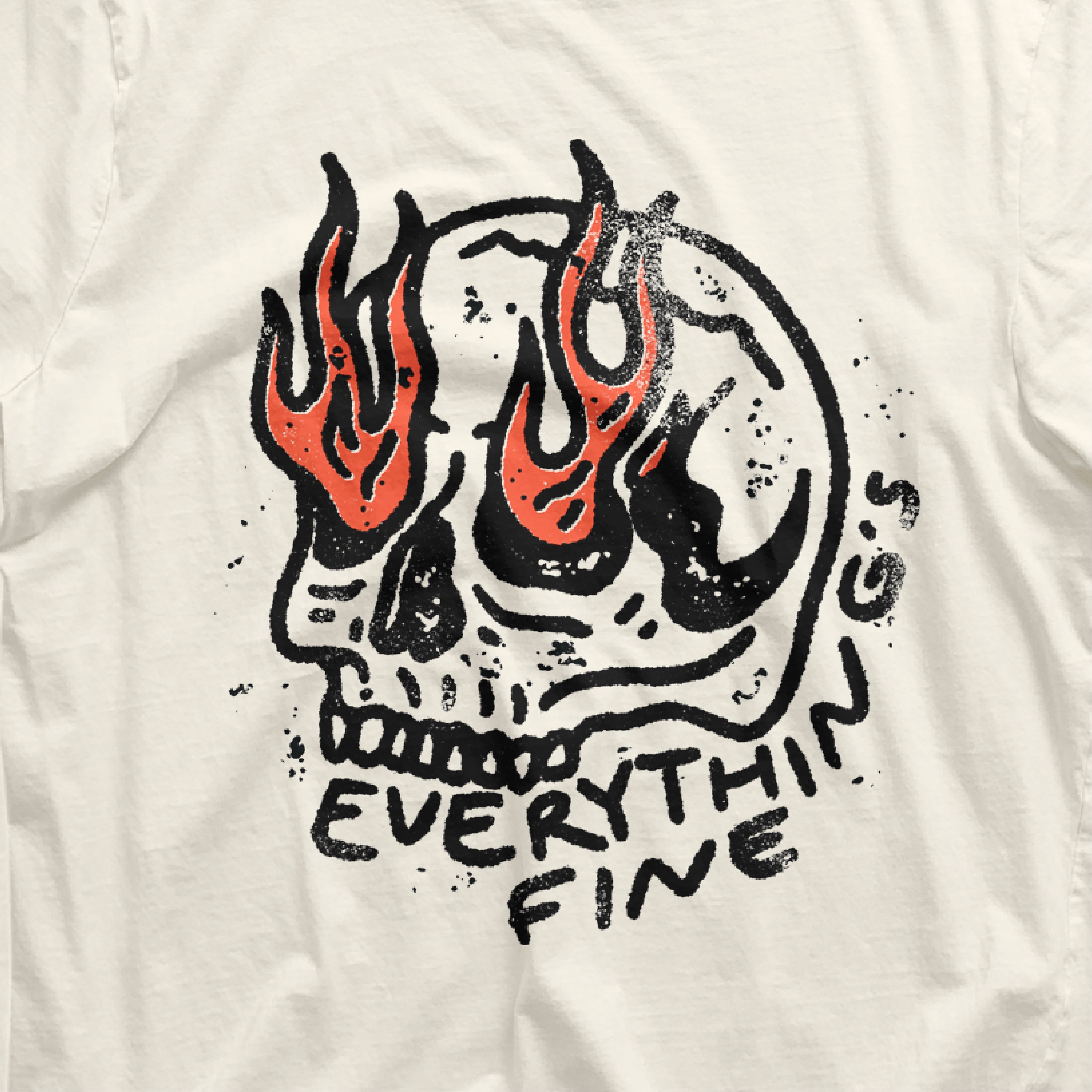 a white shirt with a skull and flames on it