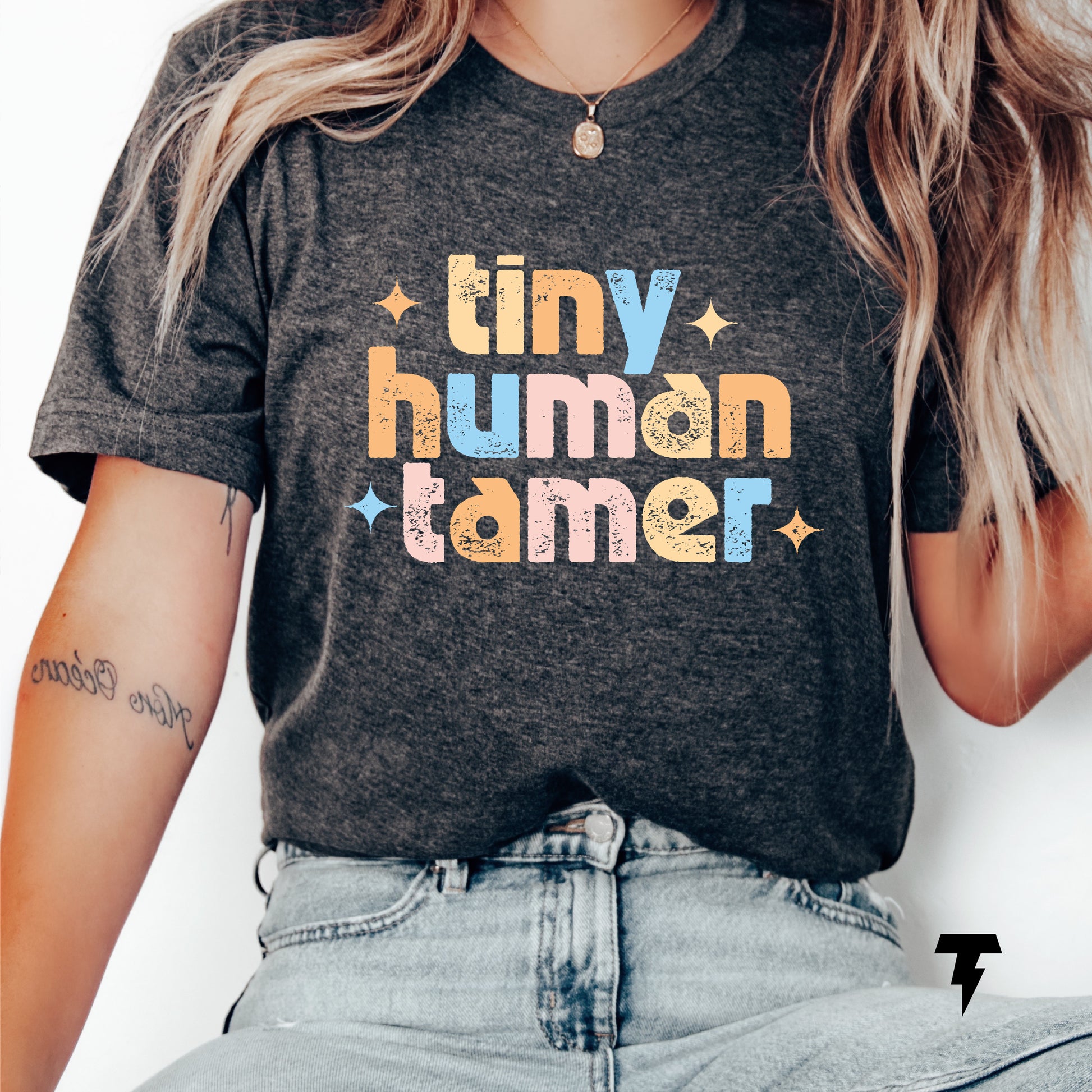 Funny teacher shirt with 'Tiny Human Tamer' text, ideal for pre-k, kindergarten, or daycare teachers, made of 100% cotton.