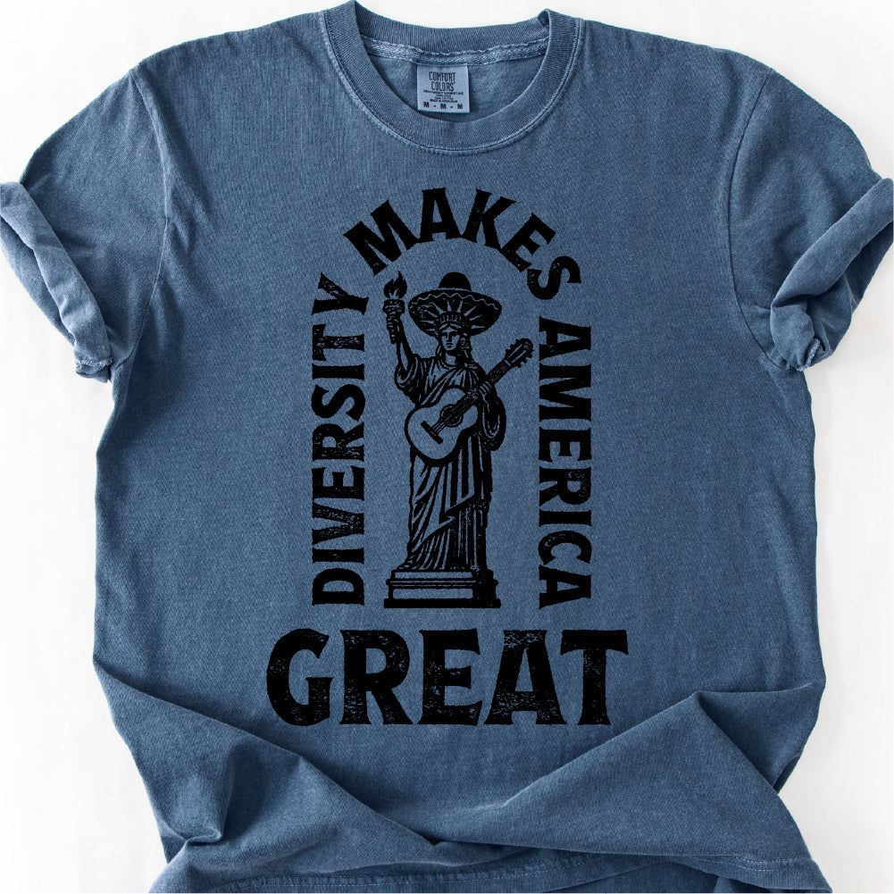 A blue t-shirt with a graphic design featuring a statue of a woman holding a guitar and the text "DIVERSITY MAKES AMERICA GREAT" printed on it.