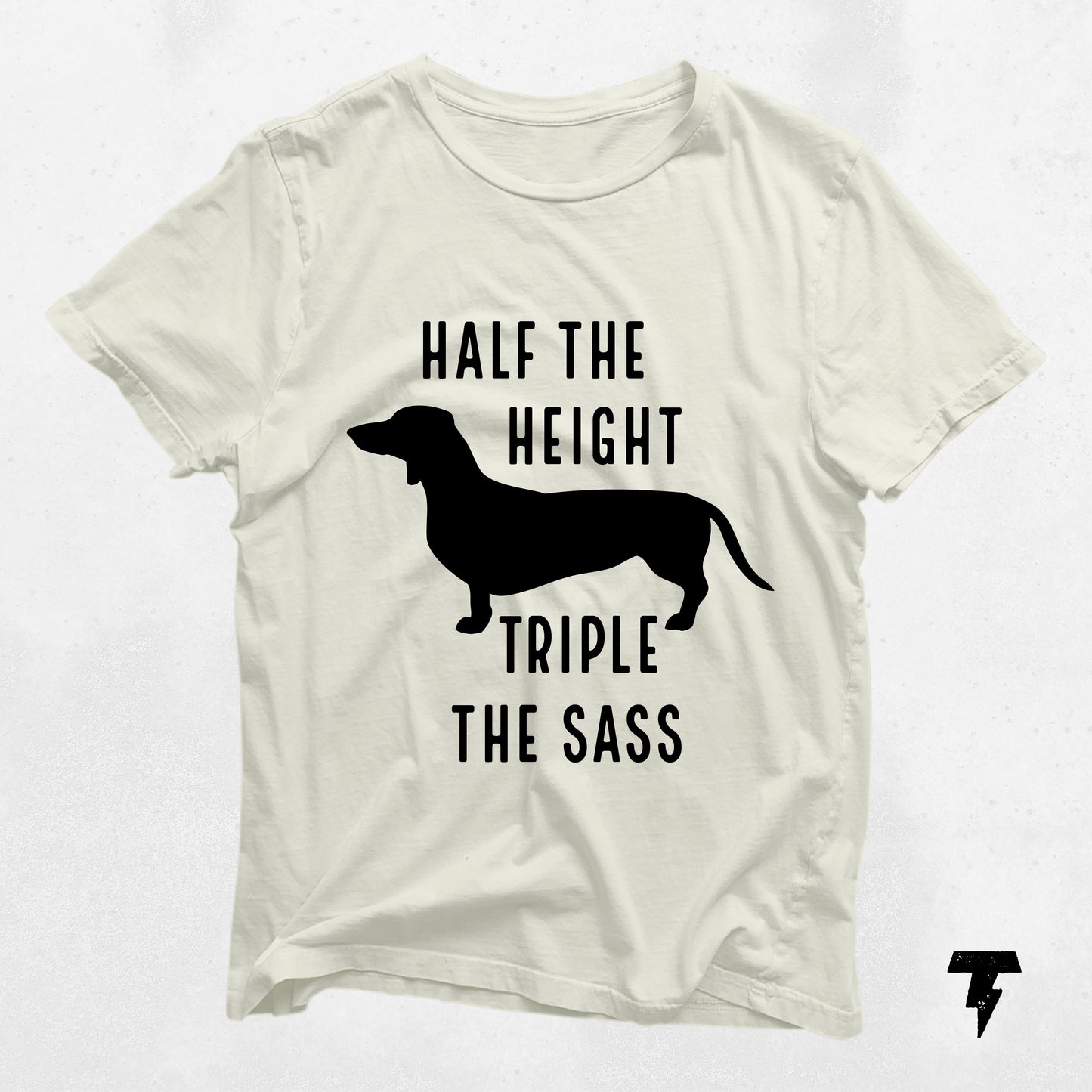 White dachshund shirt with 'Half the Height Triple the Sass' text, perfect gift for dog moms. Fun wiener dog apparel.