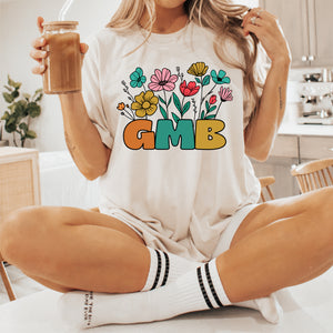 a woman sitting on a table holding a glass of coffee