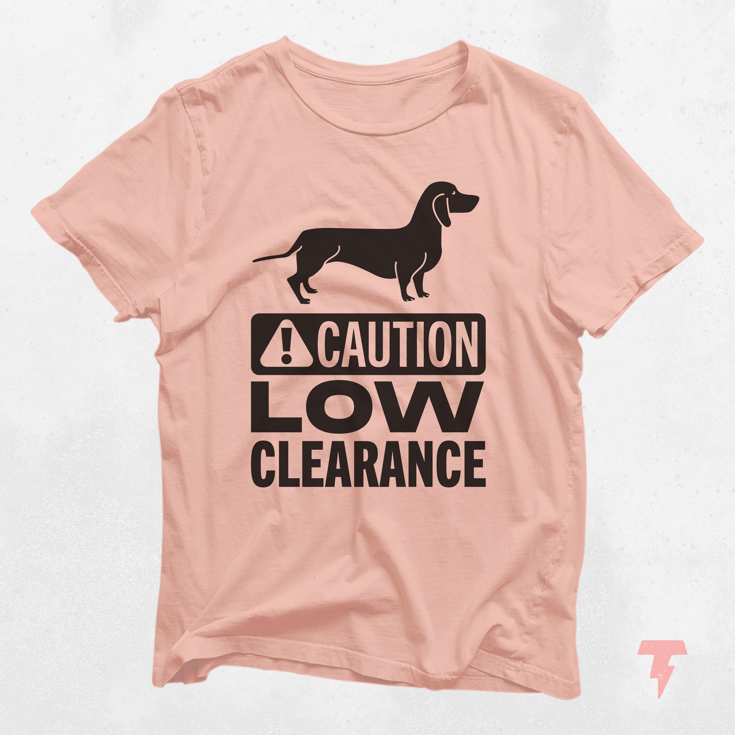 Peach Dachshund shirt with 'Caution Low Clearance' text, ideal gift for dog moms, made of soft cotton with playful wiener dog print.