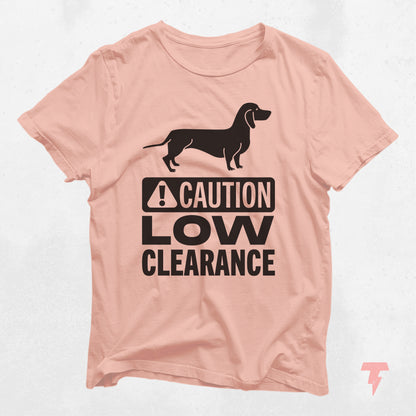 Peach Dachshund shirt with 'Caution Low Clearance' text, ideal gift for dog moms, made of soft cotton with playful wiener dog print.