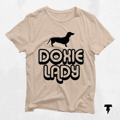 Doxie Lady Dachshund shirt in beige with black print, featuring a dachshund silhouette, perfect gift for dog moms and dachshund fans.