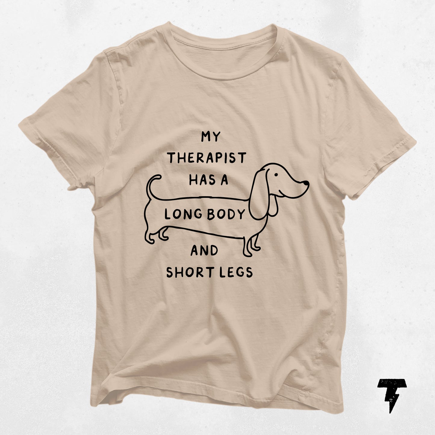 Beige dachshund shirt with 'My Therapist has a Long Body and Short Legs' print, perfect gift for dog moms.