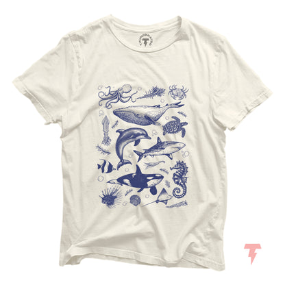 Vintage ocean wildlife shirt with illustrations of orcas, whales, dolphins, and sharks. Sea life animals on a white tee.