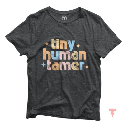 Tiny Human Tamer Shirt for teachers, featuring a colorful design on a dark cotton tee, perfect for pre-k, kindergarten, and daycare.